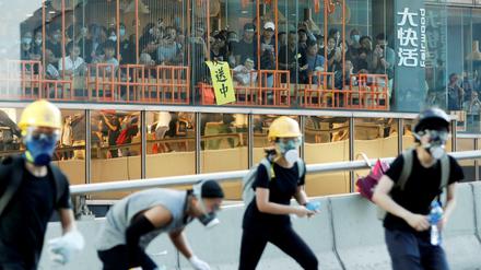 Gäste eines Restaurants in Hongkong beobachten Straßenproteste.