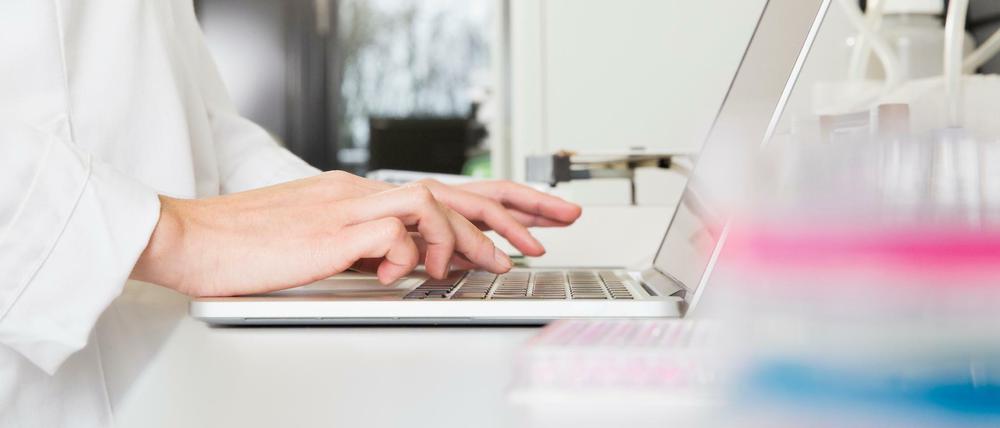 Eine Wissenschaftlerin tippt etwas in ihren Laptop ein.