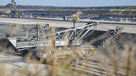 Ein riesiger Eimerkettenbagger trägt Abraum im Braunkohletagebau Jänschwalde der Lausitz ab.