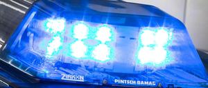 Ein Blaulicht leuchtet am auf dem Dach eines Polizeiwagens. 