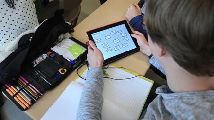 Ein Schüler arbeitet im Klassenraum mit einem Tablet-Computer.