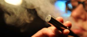 Eine Frau raucht eine elektrische Zigarette.