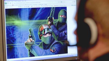 Ein junger Mann informiert sich über ein First-Person Shooter.