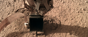 Die schwarze Schaufel des Roboterarms drückt gegen den Maulwurf (silber), damit dieser graben kann.