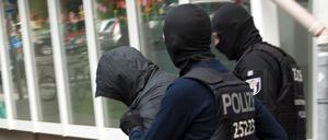 Kampf gegen Clankriminalität: Polizeibeamte führen einen Mann ab.