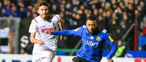Zu spät: Jonas Hector (links) und die Kölner laufen gegen Saarbrücken und Gillian Jurcher nur hinterher.