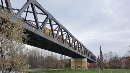 Auf einer offenen Stahlbrücke fährt die U2 durch den Gleisdreieckpark - und quietscht.