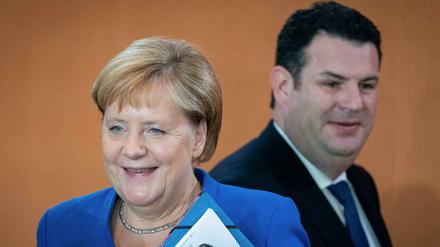 Angela Merkel (CDU) und Hubertus Heil (SPD)
