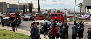Kalifornien, Santa Clarita: Einsatzwagen und Menschen stehen vor einer High School. Ein Schütze hat an der High School zwei Menschen getötet.