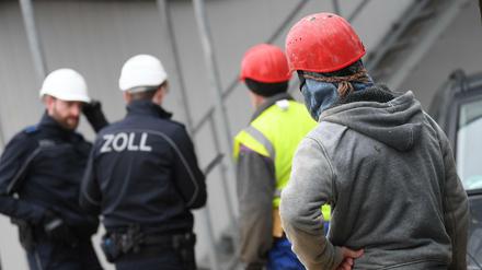 Zollbeamte kontrollieren Bauarbeiter