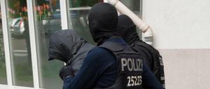 Polizeibeamte führen dreieinhalb Monate nach dem spektakulären Diebstahl einer 100-Kilo-Goldmünze aus dem Berliner Bode-Museum einen Mann ab.