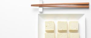 Tofu diced and served in a square plate, flat lay, view from above, space for a text