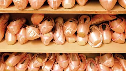 Unzählige Ballettschuhe in einem Regal.