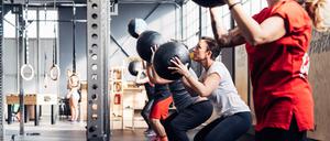 Group of people in gym using medicine balls