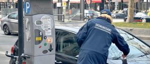  Ordnungsamt und Parksünder, Ordnungsamt, Frau, Parkraumüberwachung, Parkautomat, Auto, Parksünder, Knöllchen, Bußgeldbescheid Gesellschaft Ordnungsamt Strafzettel Symbolfoto GER Berlin xdp x0x 2013 quer