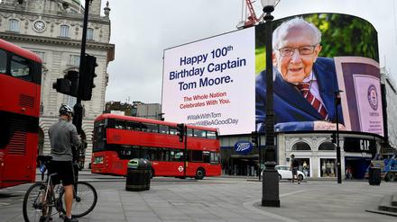 Am Piccadilly Circus in London hängt ein Plakat mit Glückwünschen für Tom Moore zum 100. Geburtstag.