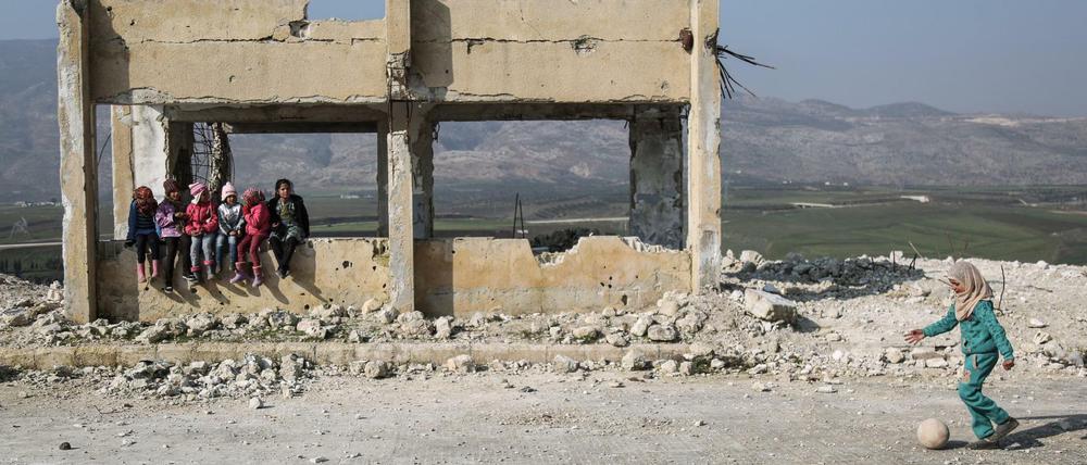 Kinder in den Trümmern einer schwer beschädigten Schule in Syrien