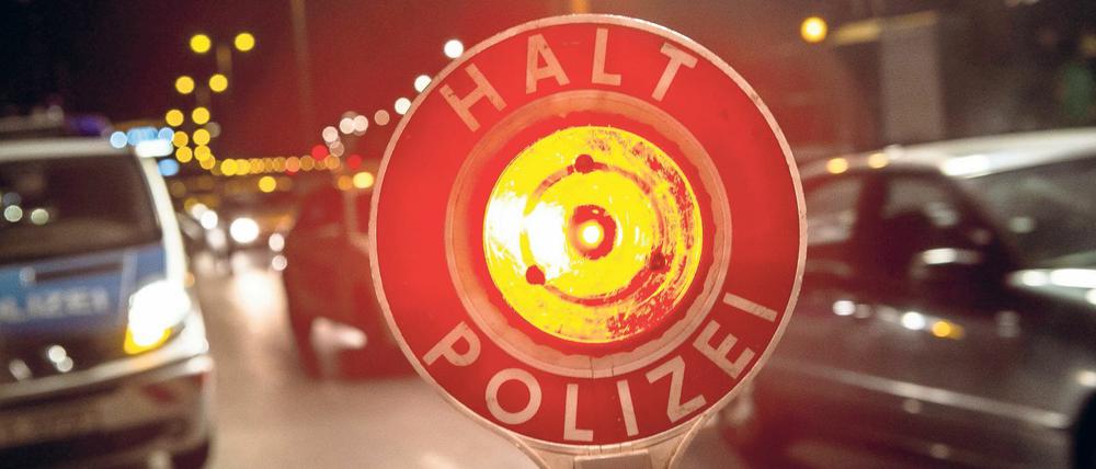 Ein Polizist stoppt am 18.09.2014 in Berlin auf der Autobahn 100 unweit der Aus- und Einfahrt Beusselstraße mit seiner Kelle einen Pkw. Beim bundesweiten Blitzer-Marathon geht die Polizei in der Hauptstadt an verschiedenen Kontrollstellen gegen Raser vor. Foto: Paul Zinken/dpa +++(c) dpa - Bildfunk+++