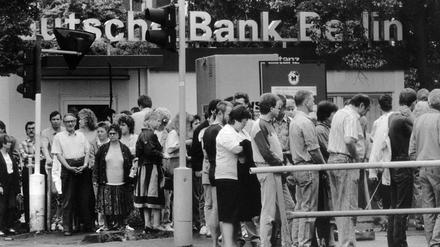 Schlange stehen fürs neue Geld. Stundenlang warteten DDR-Bürger, um die ersehnte D-Mark zu erhalten. 