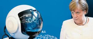 Skeptisch beäugt Angela Merkel die digitale Zukunft, einen „Pflegeroboter“. 