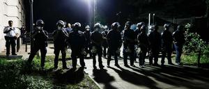 Polizisten beobachten Demonstranten, die sich in einem Protestcamp vor dem Rathaus versammeln am 20. Juni 2020. 