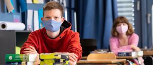 Schüler und Schülerinnen einer 12. Klasse des Lise-Meitner-Gymnasiums in Bayern nehmen am Unterricht teil und tragen Mundschutze.