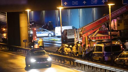 Kriminaltechniker untersuchen auf der Berliner Stadtautobahn A100 einen Pkw. 