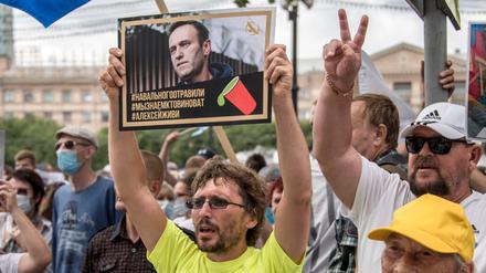 Ein Mann hält bei einer Demonstration in Russland ein Foto von Nawalny, auf dem zu lesen ist: "Nawalny wurde vergiftet, wir wissen, wer schuld ist, Alexej du musst leben". 