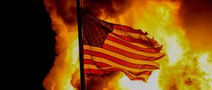 Proteste in Kenosha nach Schüssen auf einen Schwarzen: Eine US-Flagge weht über einem Gebäude, das in Brand stand.