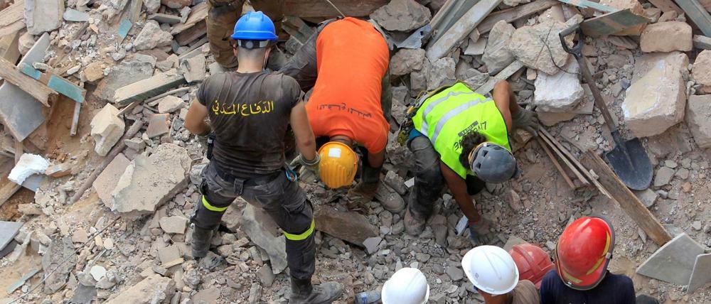 Helfer in den Trümmern von Gebäuden in Beirut