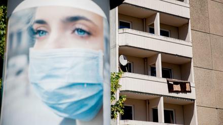 Eine Reklame der Werbemittel-Firma MS-Print für Mundschutze, die sie vertreiben, ist vor einem Wohnblock nahe des Ostbahnhofs im Berliner Zentrum zu sehen.