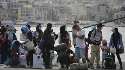 Migranten stehen Schlange, um eine Fähre von der Insel Lesbos zum griechischen Festland zu besteigen. 