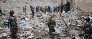 Soldaten und Feuerwehrleute suchen nach Überlebenden in einem Wohngebiet.