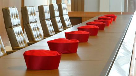 Die Barette der Verfassungsrichter liegen vor einer Verhandlung aufgereiht auf dem Tisch - bald geht es um den Mietendeckel