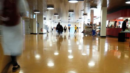 Studierende gehen durch das Foyer zwischen Silber- und Rostlaube an der Freien Universität Berlin.
