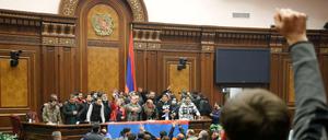 Menschen schreien lautstark im von ihnen besetzten Parlamentsgebäude in Eriwan.