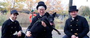 Die Schornsteinfeger Ilian Romero, Schornsteinfeger Norbert Skrobek, Schornsteinfeger Alain Raabsilber werben im Tierheim Berlin für die Vermittlung von schwarzen Tieren, wie Bonnie.