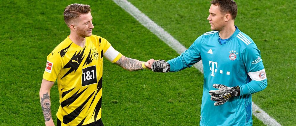 Faust drauf. Dortmunds Kapitän Marco Reus (l) begrüßt Bayerns Kapitän und Torhüter Manuel Neuer vor dem Spiel. 