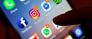 Ein Blick auf ein Smartphone mit den verschiedenen Social Media Apps, wie Facebook, Instagram, YouTube und WhatsApp. 
