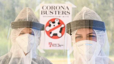 Mitarbeiter vom Gesundheitsamt in Mitte stehen in Schutzkleidung auf dem zentralen Festplatz in der ambulanten Corona-Test-Einrichtung.
