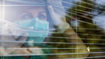 Concerned Healthcare worker looking through a window