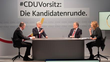 Friedrich Merz, Norbert Röttgen und Armin Laschet joined by presenter Tanja Samrotzki, take part in a discussion at the party&amp;apos;s headquarters in Berlin, Germany December, 14, 2020. Background slogan reads: "CDU Chairmanship: The candidate round". Markus Schreiber/Pool via REUTERS