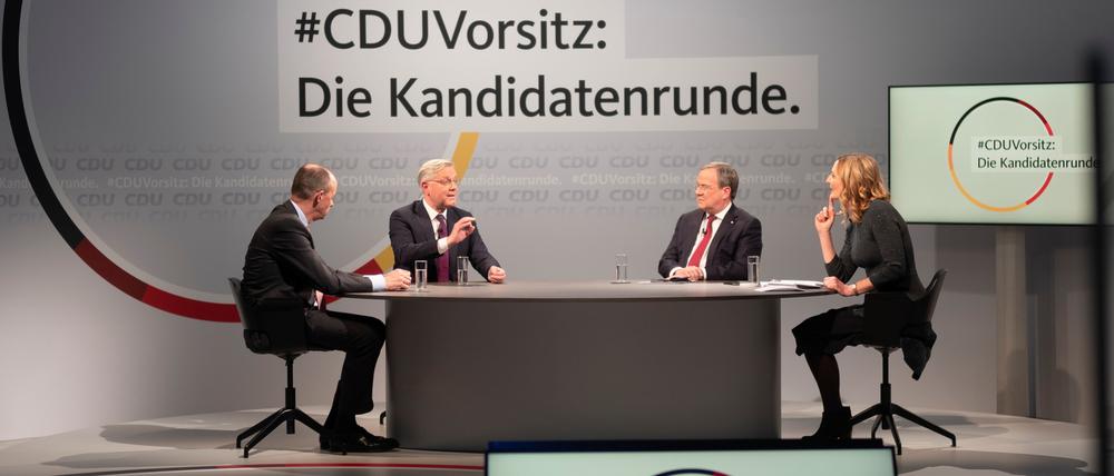 Friedrich Merz, Norbert Röttgen und Armin Laschet joined by presenter Tanja Samrotzki, take part in a discussion at the party&amp;apos;s headquarters in Berlin, Germany December, 14, 2020. Background slogan reads: "CDU Chairmanship: The candidate round". Markus Schreiber/Pool via REUTERS
