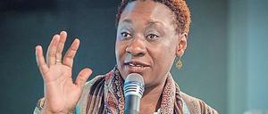 Maureen Maisha Auma spricht gestikulierend in ein Mikrofon.