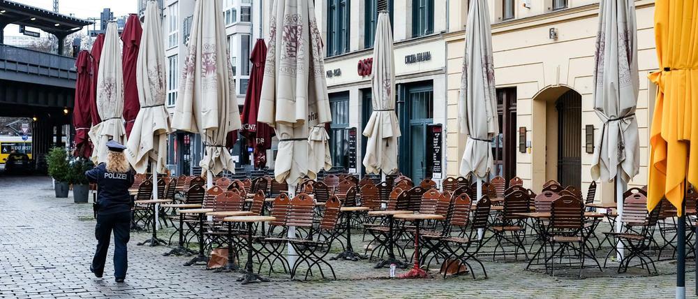 Eine Polizistin geht über den leeren Hackeschen Markt in Berlin.