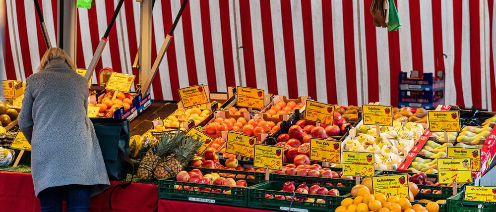 Berliner Wochenmarkthändlerin sortiert ihre Lebensmittel-Ware.