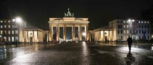 Ein Mann läuft über den ansonsten menschenleeren Pariser Platz vor dem Brandenburger Tor.