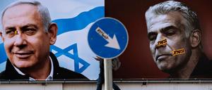 Männer, die ins Ungewisse starren. Wahlkampfplakate für den rechtskonservativen Likud und dessen Vorsitzender Benjamin Netanjahu (l), Premierminister von Israel, und Oppositionsführer Yair Lapid von der liberalen Partei Jesch Atid in Ramat Gan, unweit von Tel Aviv.