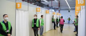 Helfer warten im Terminal C des ehemaligen Flughafens Tegel im Corona-Impfzentrums vor den Impfkabinen auf Patienten.