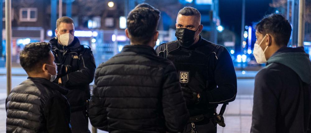 In Hagen gilt derzeit eine Ausgangssperre von 21 bis 5 Uhr. Mitarbeiter des Ordnungsamts weisen Passanten im Stadtzentrum auf diese Regel hin.